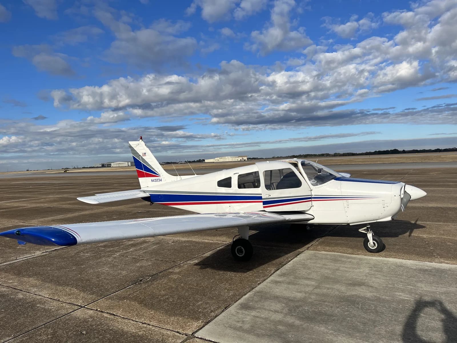 Piper Cherokee on the ramp at 71J under a blue Alabama sky