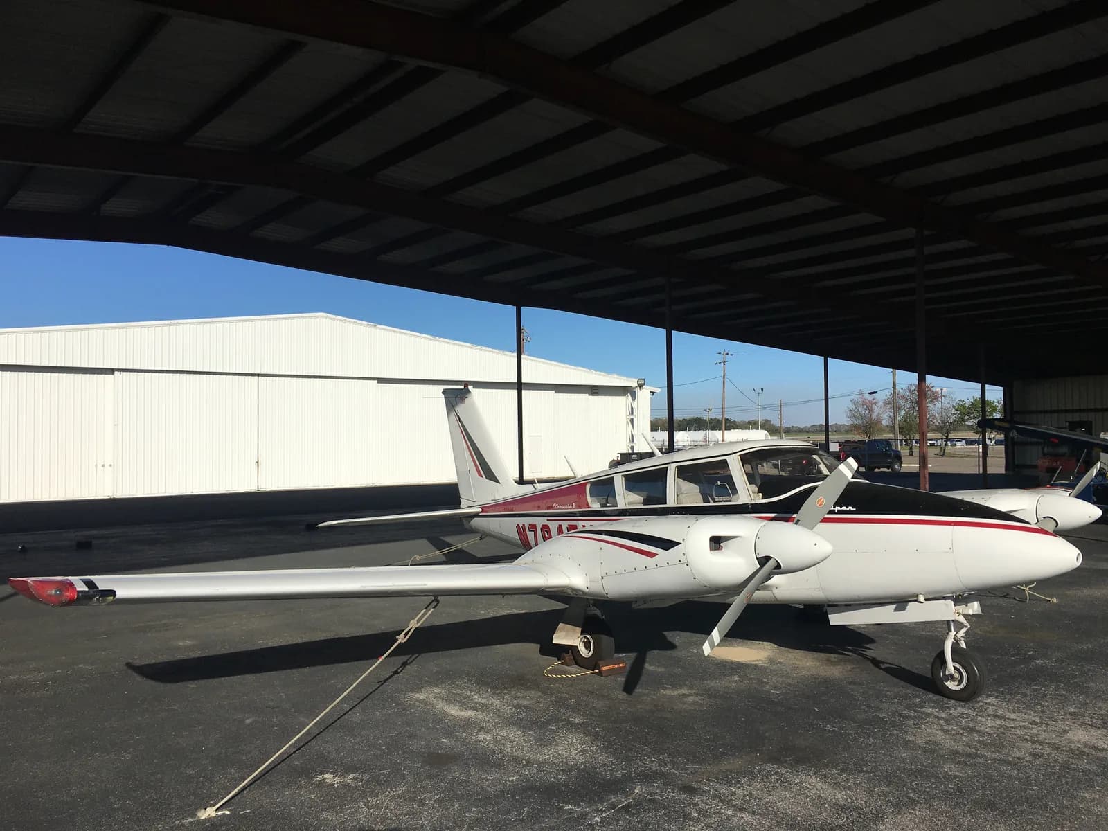 Twin Comanche, side view, parked at 71J