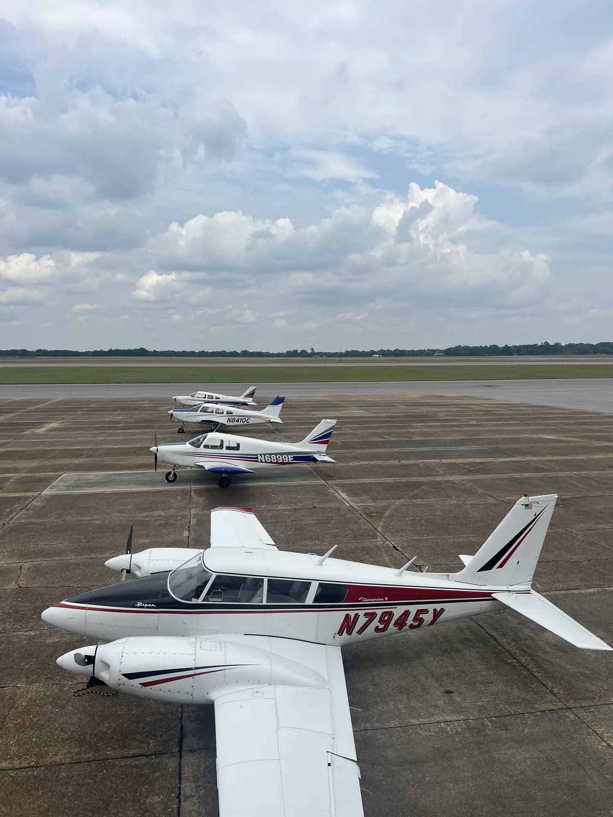 ACOM Aviation fleet — Twin Comanche and Cherokees on the ramp at Ozark-Blackwell Airport (71J)